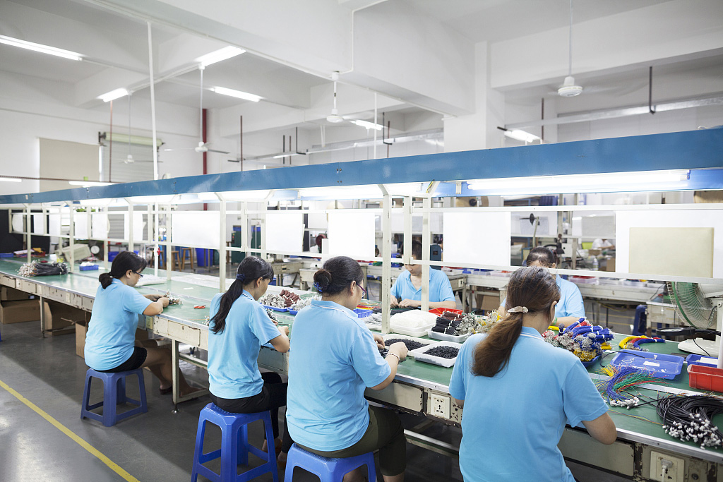 Workers at an electronics factory in Dongguan, China